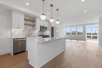 a large white kitchen with an island and stainless steel appliances at Rialto, Washington District of Columbia